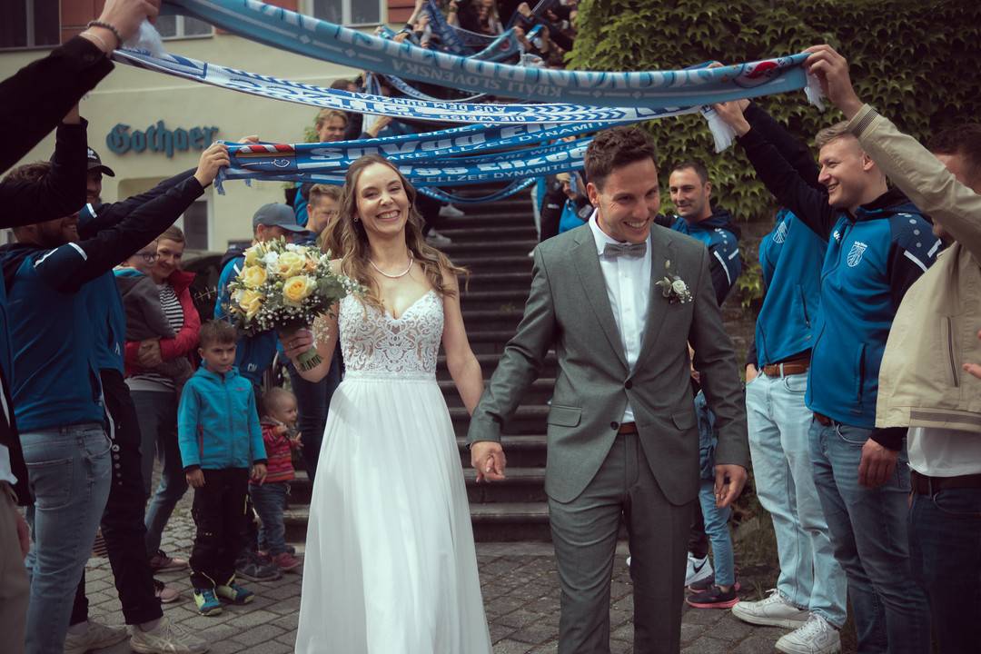 Hochzeit Standesamt Waldstetten: Brautpaar lacht unter den Fanschals der SpVgg Ellzee